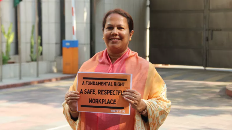 This is a photo of an ILO Bangladesh female staff member sending a key message on what the ILO does - working for safe, respectful work environments.